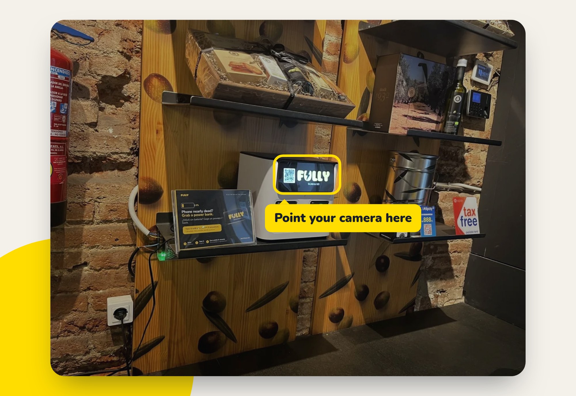 A Fully power bank station on a shop shelf in Barcelona, with the QR code on its screen highlighted
